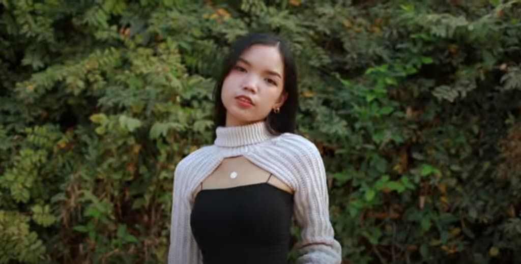 a young woman in a knit bodiless sweater