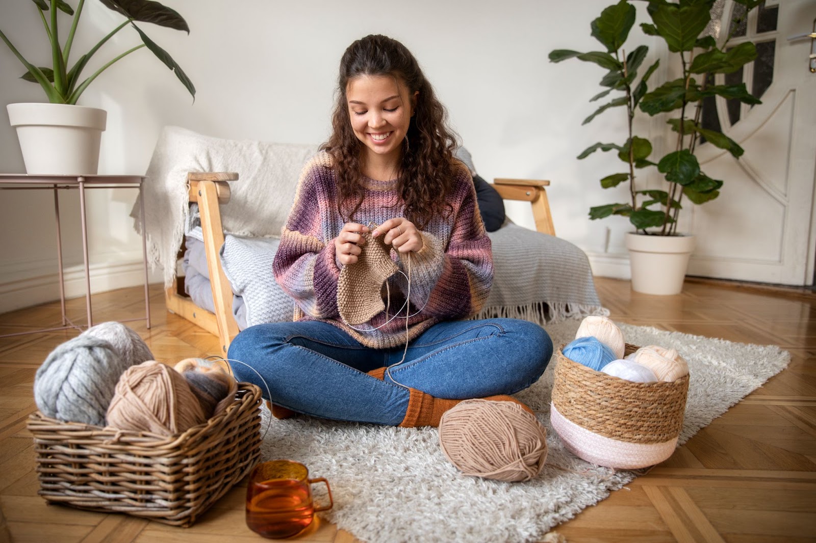 Happy woman knitting at home