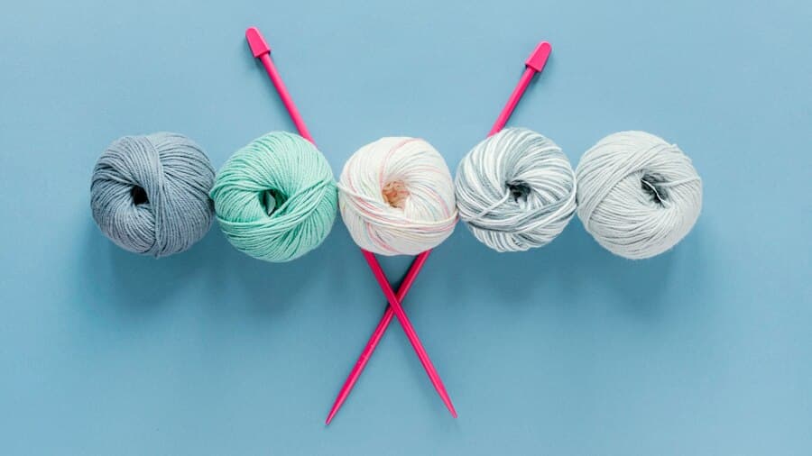 Knitting Needles and Multicolored Skeins of Wool