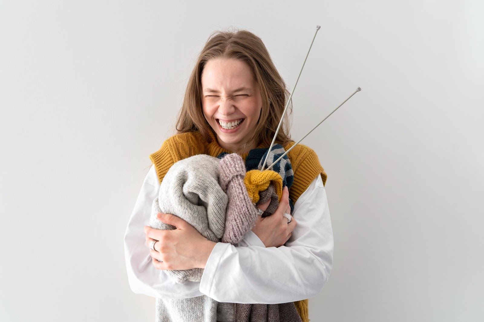 Happy woman with knitting tools